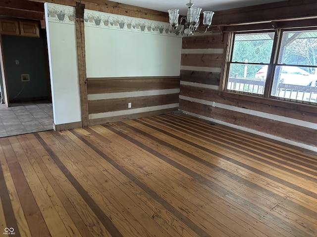 10770 W 650 S, Columbus, IN 47201 - unfurnished dining area with an inviting chandelier, wooden walls, and hardwood / wood-style flooring