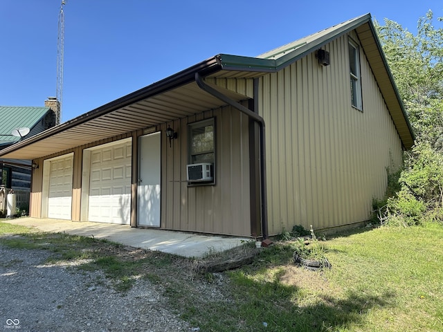 10770 W 650 S, Columbus, IN 47201 - view of side of property with a garage, a chimney, cooling unit, driveway, and metal roof
