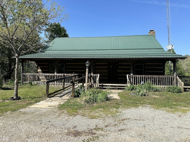 10770 W 650 S, Columbus, IN 47201 - cabin featuring log exterior, metal roof, a chimney, and a standing seam roof
