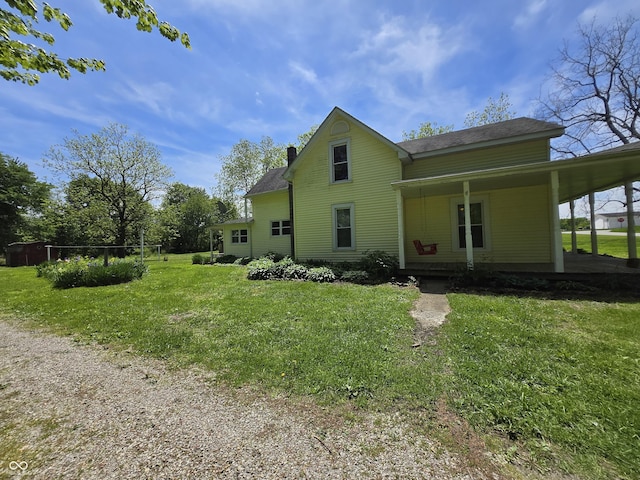 7561 N Hall School Rd, Monrovia, IN 46157 - back of house with a lawn, a chimney, covered porch, and roof with shingles