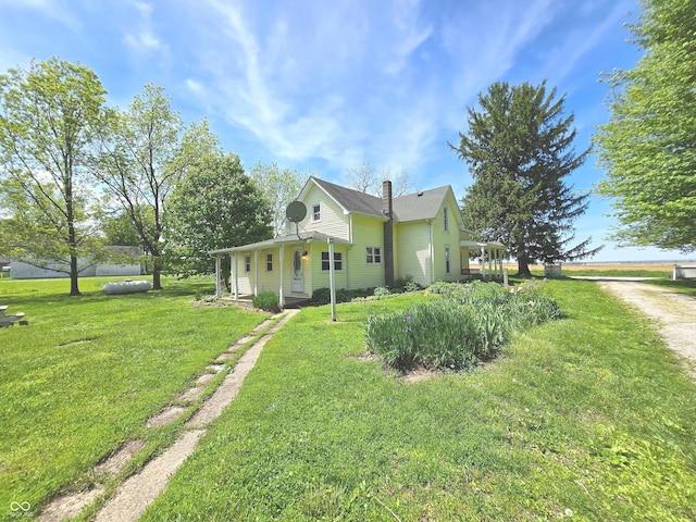 7561 N Hall School Rd, Monrovia, IN 46157 - view of side of home featuring a yard, driveway, and a chimney