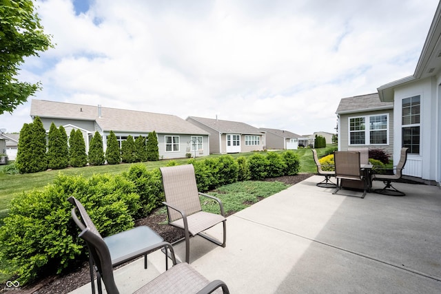 view of patio / terrace with outdoor dining space and a residential view