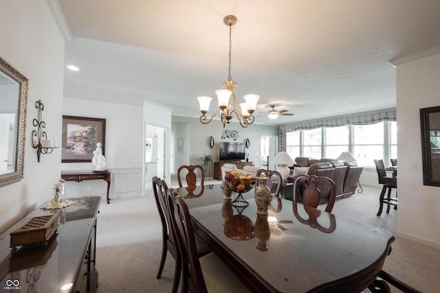 dining space featuring light colored carpet, a chandelier, and crown molding