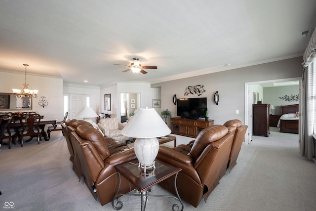 living area with light carpet, ornamental molding, a chandelier, and ceiling fan