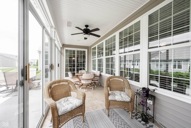 sunroom with a ceiling fan