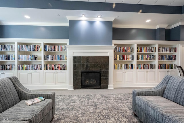 living room with crown molding, a fireplace, carpet, recessed lighting, and built in shelves