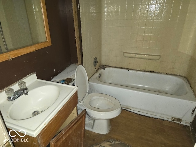 bathroom featuring wood finished floors, toilet, and vanity