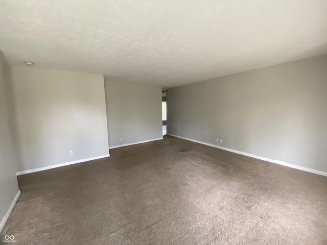 carpeted spare room with baseboards