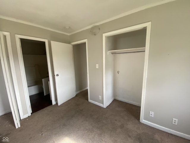 unfurnished bedroom featuring baseboards, crown molding, a closet, and carpet flooring