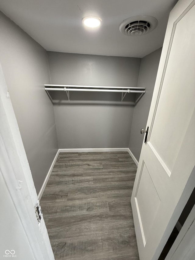 walk in closet featuring visible vents and wood finished floors
