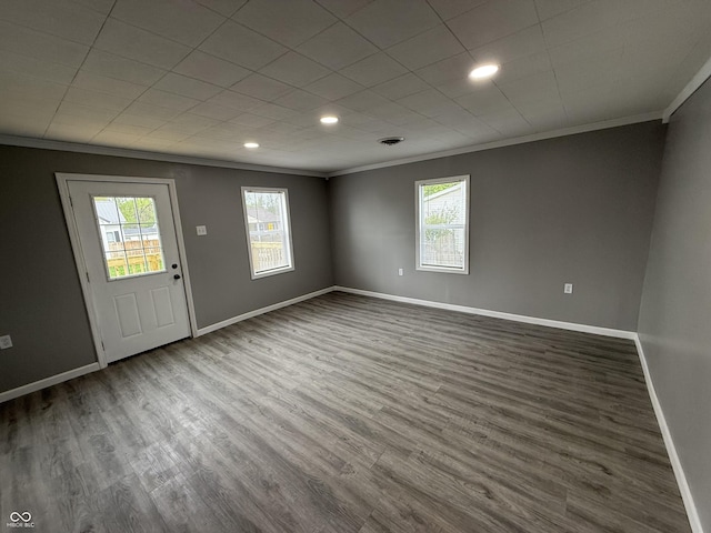 entrance foyer featuring a healthy amount of sunlight and crown molding