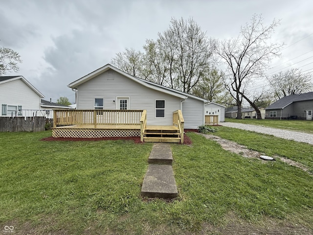 view of front of home with fence, a front yard, and a wooden deck