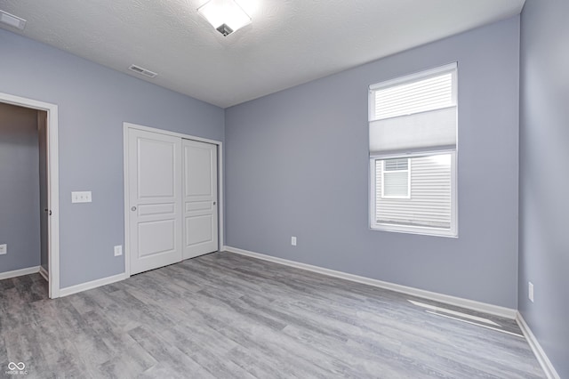 5110 Lilium Dr, Plainfield, IN 46168 - unfurnished bedroom featuring wood finished floors, a closet, and a textured ceiling