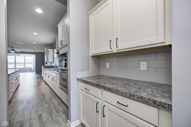 5110 Lilium Dr, Plainfield, IN 46168 - kitchen featuring decorative backsplash, light wood-style flooring, a ceiling fan, white cabinetry, and recessed lighting