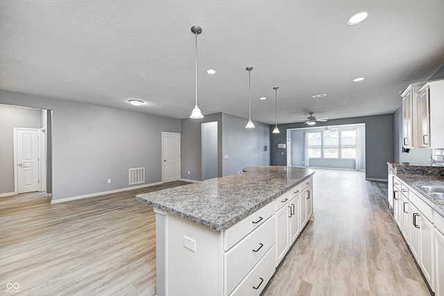 5110 Lilium Dr, Plainfield, IN 46168 - kitchen featuring open floor plan, a kitchen island, a ceiling fan, light wood-style flooring, and recessed lighting