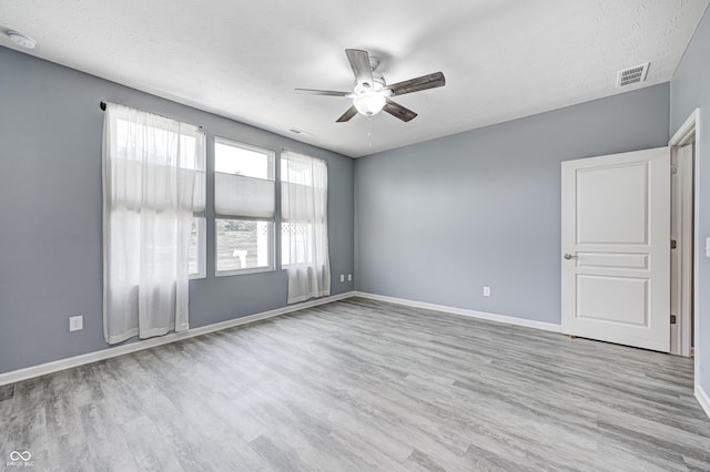 5110 Lilium Dr, Plainfield, IN 46168 - empty room with a ceiling fan, wood finished floors, a textured ceiling, and a smoke detector