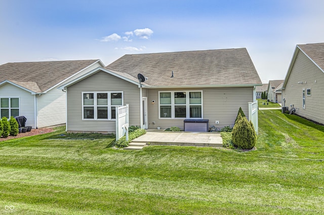 5110 Lilium Dr, Plainfield, IN 46168 - back of property featuring a patio, a lawn, and a shingled roof
