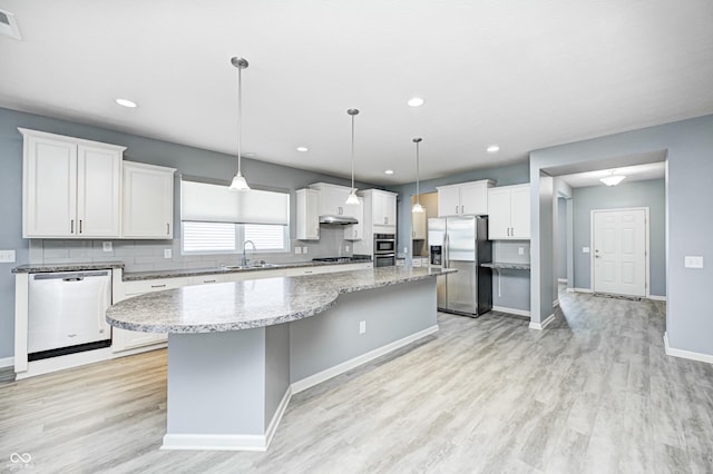 5110 Lilium Dr, Plainfield, IN 46168 - kitchen with stainless steel appliances, a center island, light wood-style flooring, white cabinetry, and recessed lighting