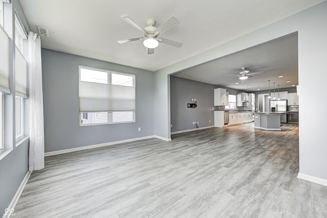 5110 Lilium Dr, Plainfield, IN 46168 - unfurnished living room with ceiling fan, healthy amount of natural light, light wood-style floors, and recessed lighting