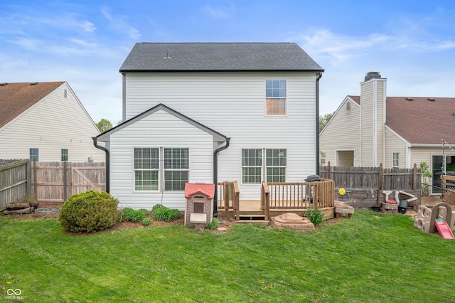 rear view of house featuring a lawn, a fenced backyard, roof with shingles, and a wooden deck
