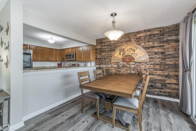 8140 Shorewalk Dr Unit C, Indianapolis, IN 46236 - dining area featuring wooden walls, baseboards, beverage cooler, and wood finished floors