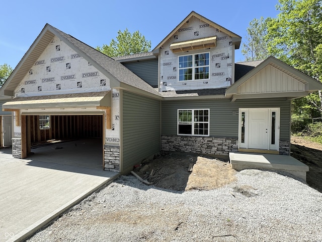 464 Mill Spgs, Coatesville, IN 46121 - view of front of house with concrete driveway, stone siding, an attached garage, and roof with shingles