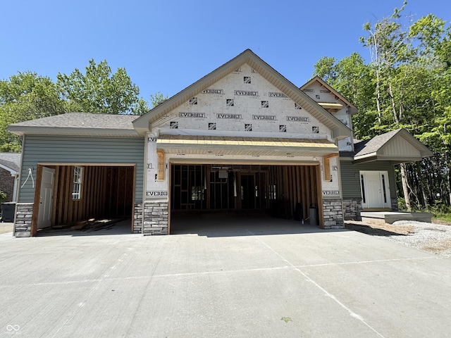 464 Mill Spgs, Coatesville, IN 46121 - unfinished property with an attached garage, stone siding, and driveway
