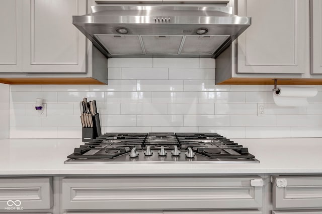 15120 Downham Dr, Fishers, IN 46037 - kitchen featuring ventilation hood, light countertops, decorative backsplash, and stainless steel gas cooktop
