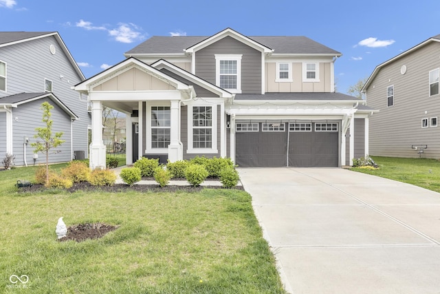 15120 Downham Dr, Fishers, IN 46037 - view of front of home with concrete driveway, board and batten siding, and a front lawn