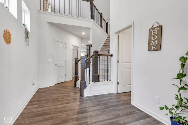 15120 Downham Dr, Fishers, IN 46037 - foyer featuring baseboards, stairs, a towering ceiling, and wood finished floors