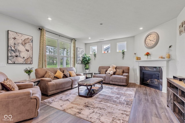 15120 Downham Dr, Fishers, IN 46037 - living area with recessed lighting, wood finished floors, and a glass covered fireplace