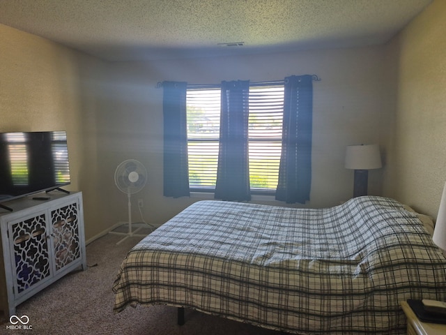 bedroom with a textured ceiling and carpet