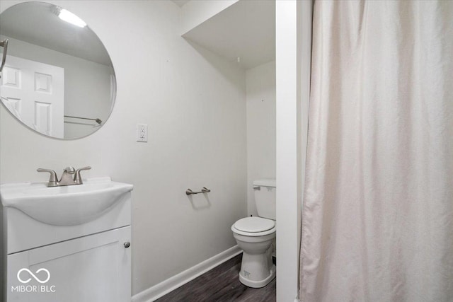 5719 Laurel Hall Dr, Indianapolis, IN 46226 - full bath featuring wood finished floors, vanity, toilet, and baseboards