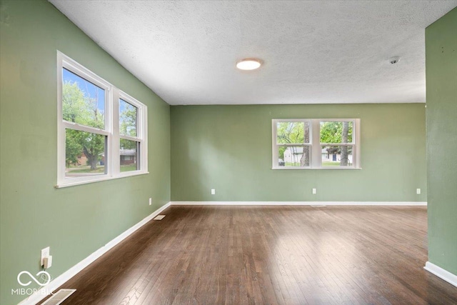 5719 Laurel Hall Dr, Indianapolis, IN 46226 - unfurnished room with healthy amount of natural light, baseboards, hardwood / wood-style flooring, and a textured ceiling