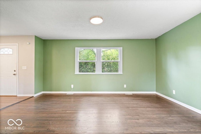 5719 Laurel Hall Dr, Indianapolis, IN 46226 - unfurnished room featuring wood finished floors, baseboards, and a textured ceiling