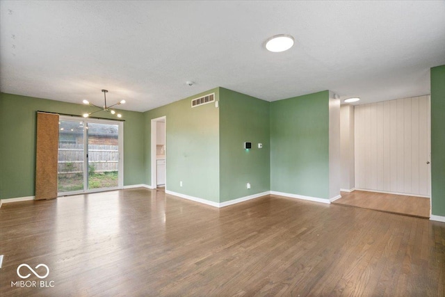 5719 Laurel Hall Dr, Indianapolis, IN 46226 - empty room with a chandelier, wood finished floors, and baseboards