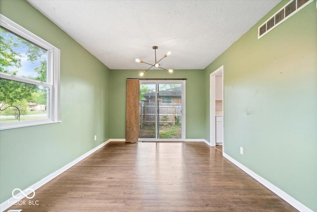 5719 Laurel Hall Dr, Indianapolis, IN 46226 - unfurnished dining area featuring a chandelier, wood finished floors, and baseboards