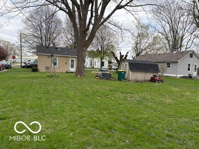 view of yard with a storage unit and an outbuilding