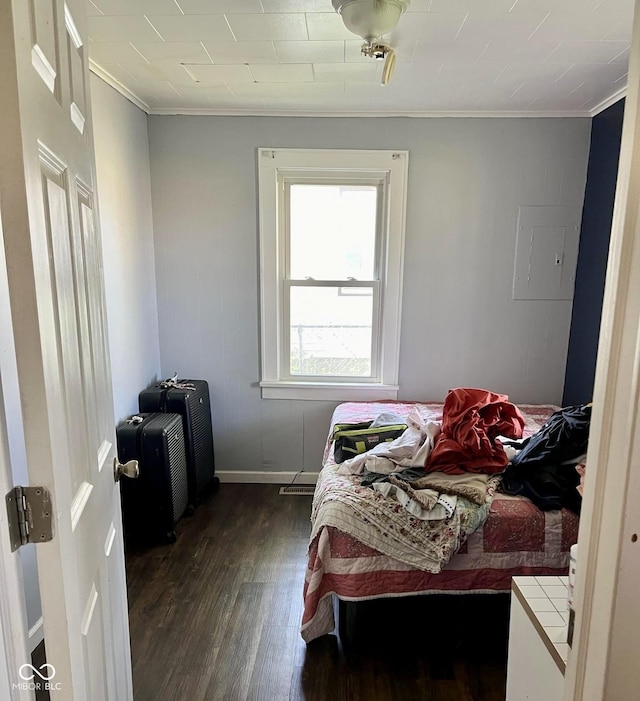bedroom with baseboards, ornamental molding, and dark wood-type flooring