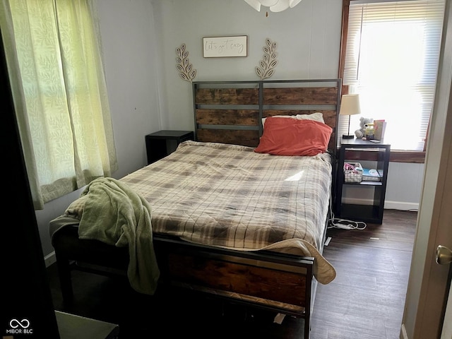bedroom featuring wood finished floors and baseboards