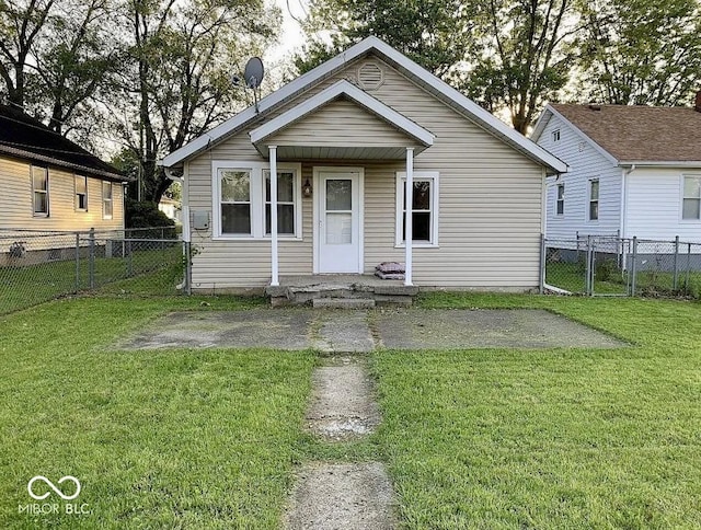 bungalow-style house with a front yard, a gate, and fence
