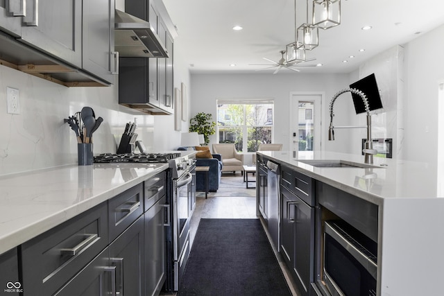 2226 Central Ave, Indianapolis, IN 46205 - kitchen with recessed lighting, a sink, appliances with stainless steel finishes, and wall chimney range hood