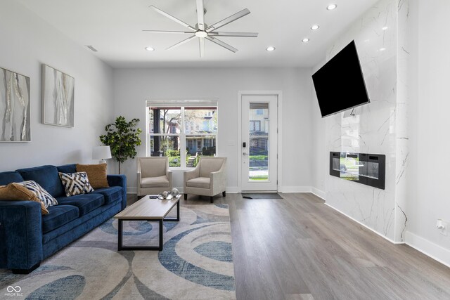 2226 Central Ave, Indianapolis, IN 46205 - living room with a premium fireplace, baseboards, recessed lighting, wood finished floors, and a ceiling fan