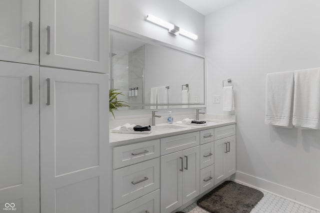 2226 Central Ave, Indianapolis, IN 46205 - bathroom with double vanity, a sink, a stall shower, and baseboards