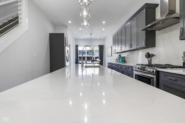 2226 Central Ave, Indianapolis, IN 46205 - kitchen featuring wall chimney range hood, appliances with stainless steel finishes, light stone countertops, recessed lighting, and hanging light fixtures