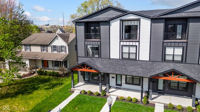 2226 Central Ave, Indianapolis, IN 46205 - view of front of property with covered porch, a front yard, and a shingled roof