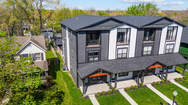 2226 Central Ave, Indianapolis, IN 46205 - view of front facade featuring a patio, a shingled roof, a front lawn, and a balcony