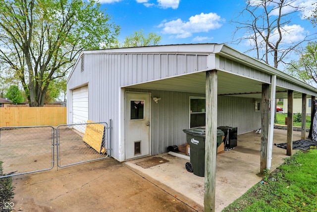 view of outbuilding featuring a gate and fence