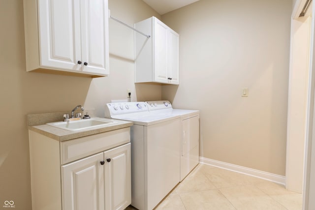 washroom with baseboards, separate washer and dryer, a sink, cabinet space, and light tile patterned floors