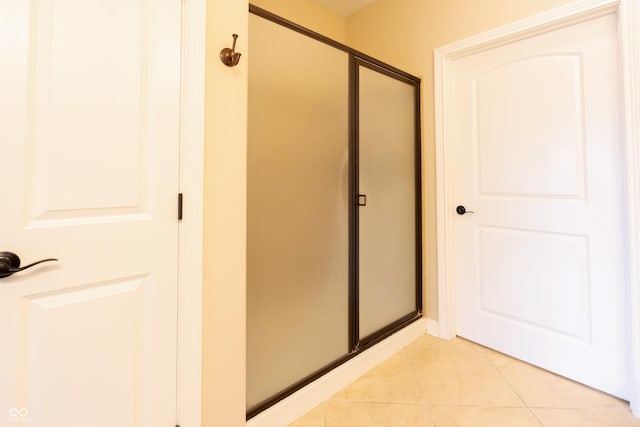 bathroom featuring tile patterned flooring and a stall shower